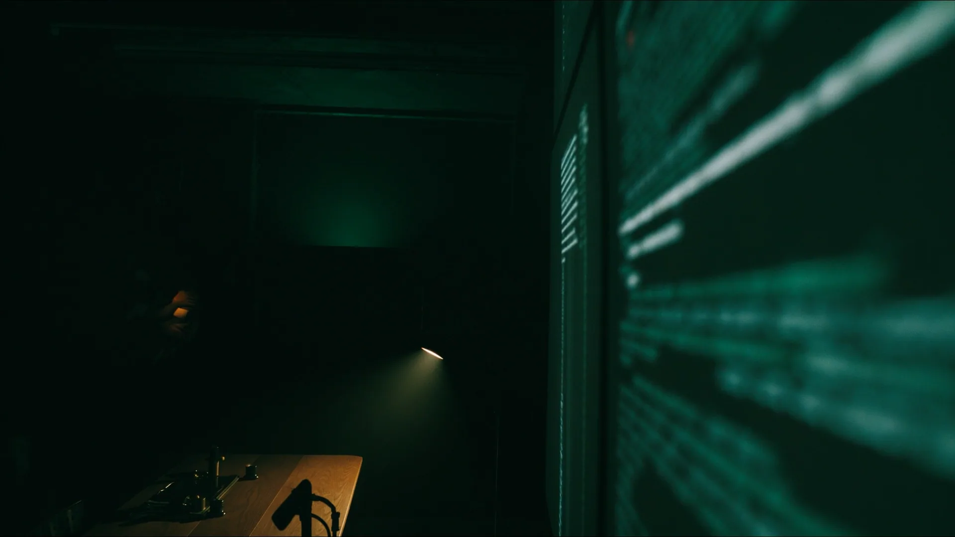 A darkened engineering studio with code glowing on a screen