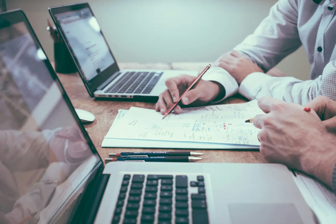 A person signing insurance paperwork at a desk